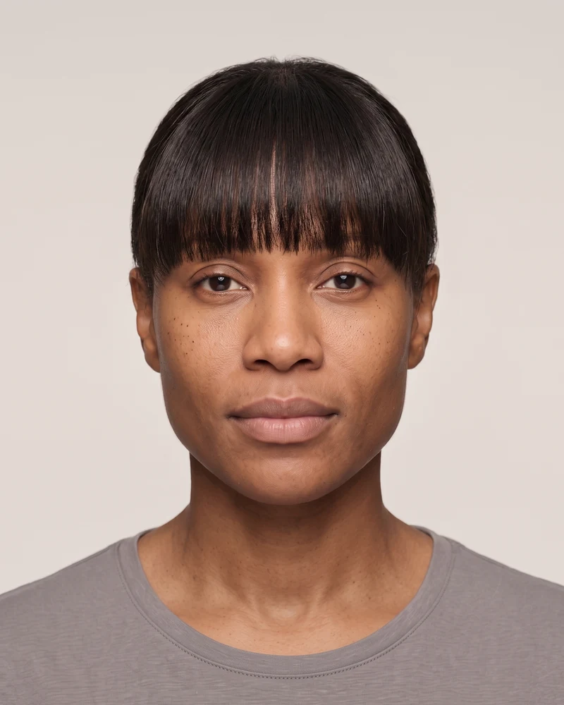 Woman with a triangle face shape wearing long thick bangs